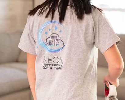 Neon Cleaning Services logo printed on the back of a team member's shirt